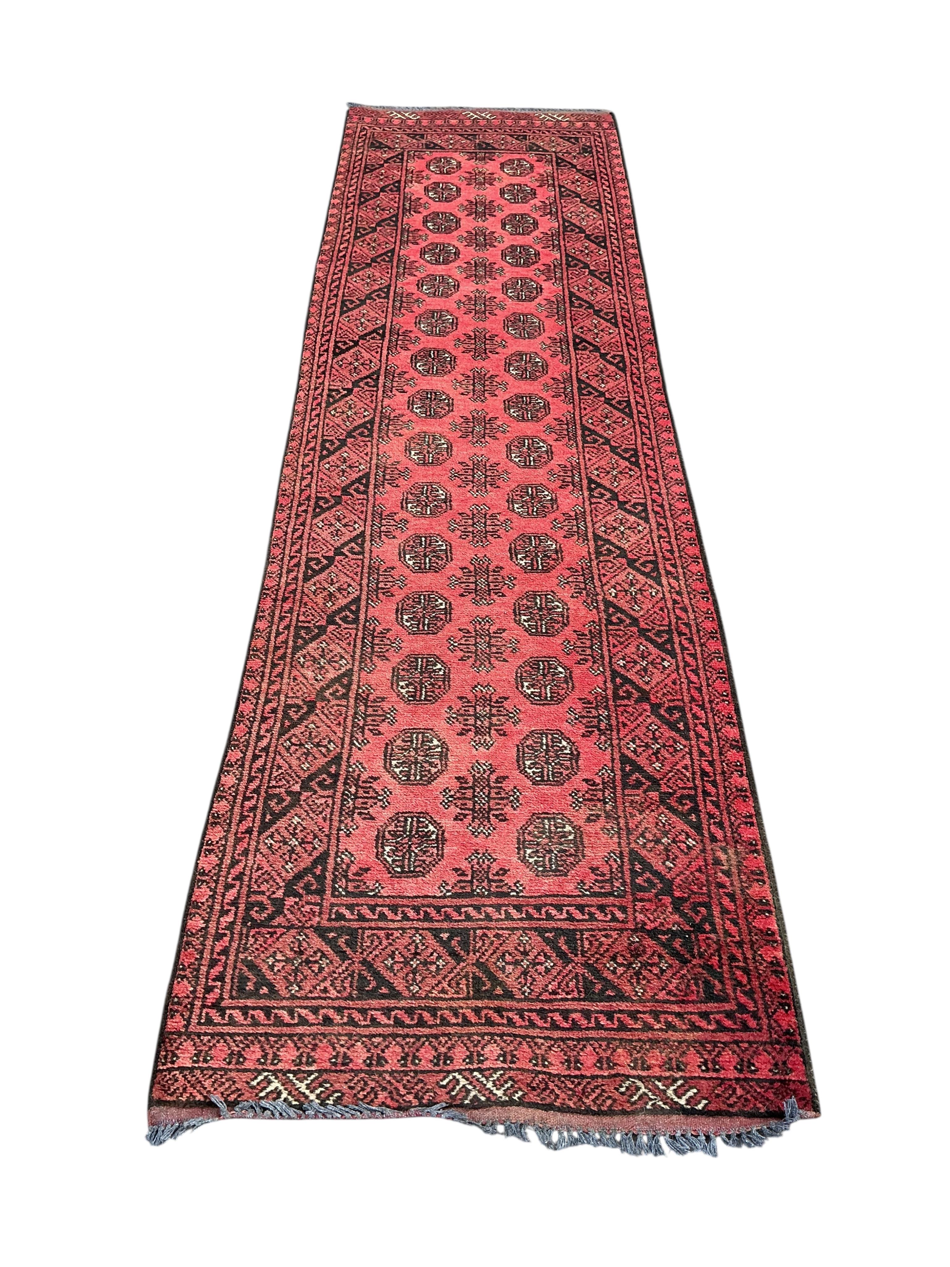 A Bokhara runner, 295 x 81cm